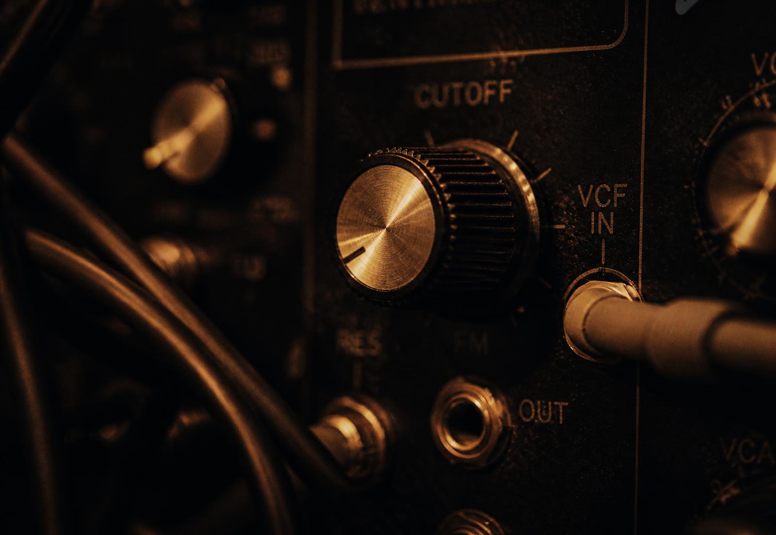 Macro detail of an analog synthesizer under warm low light